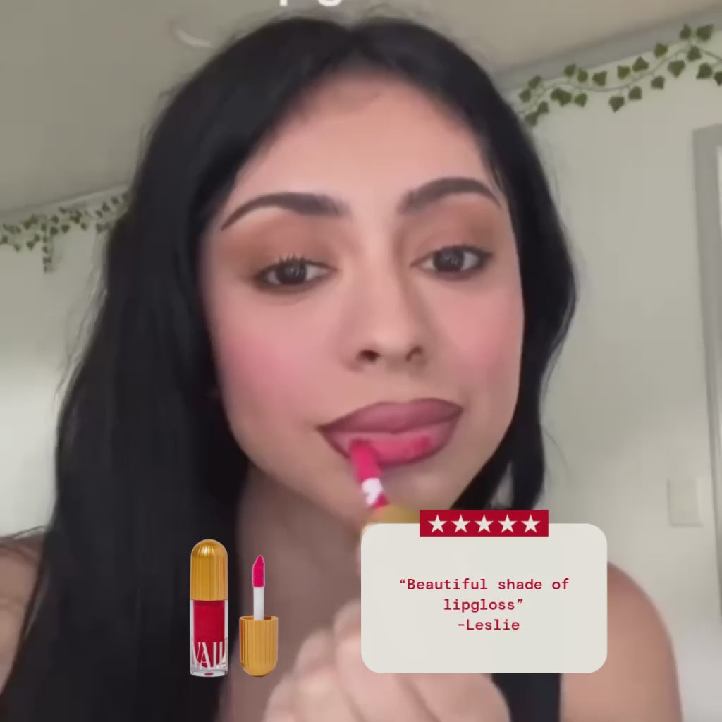 a woman apply the corazon lip gloss with a review on display that says "beautiful shade of lipgloss" by Leslie