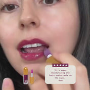 A close up of a womans face applying the colibri lip gloss with review on display saying "It’s super moisturizing and feels comfortable on the lips." by Ana